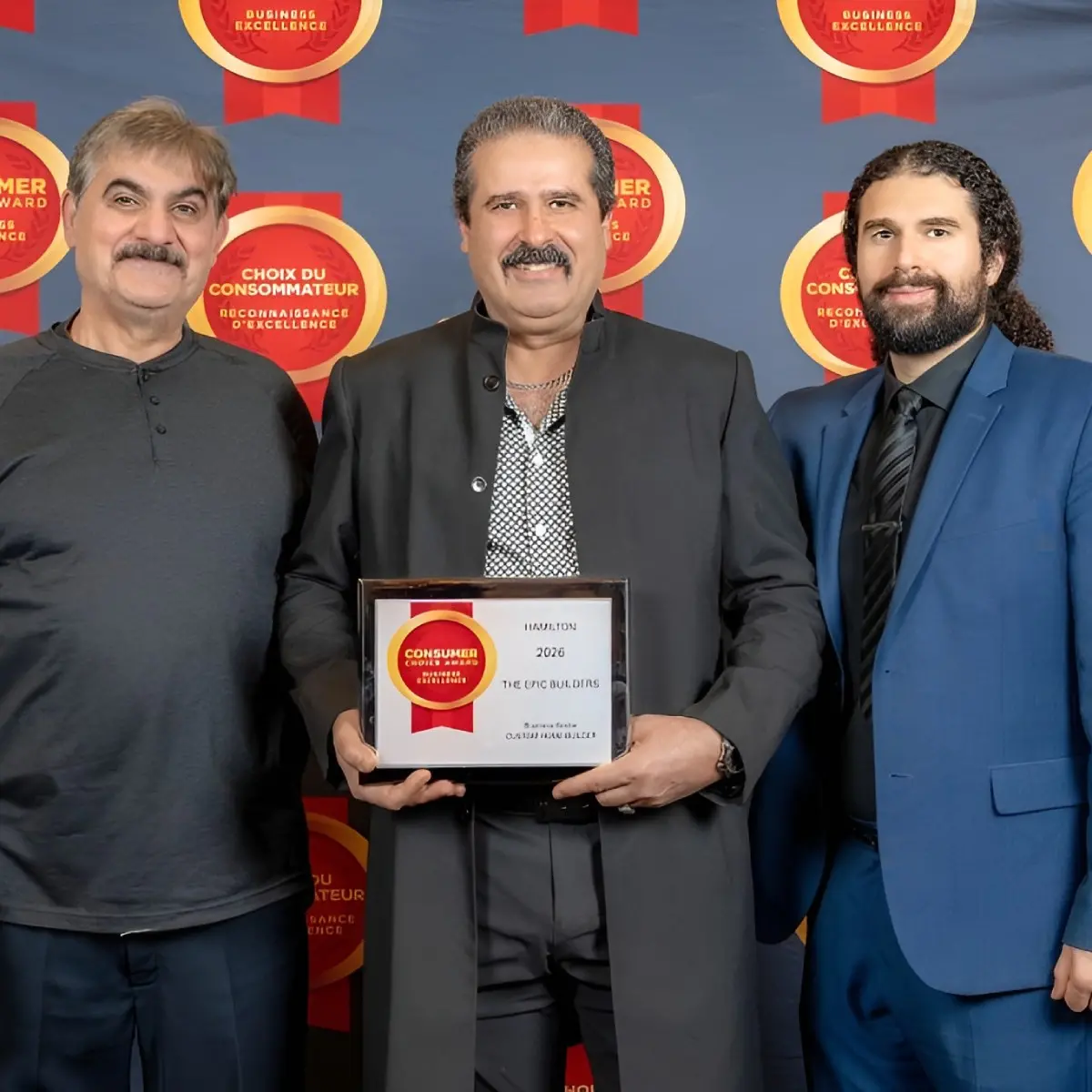 The Epic Builders team holding a 2026 Consumer Choice Award certificate in Hamilton